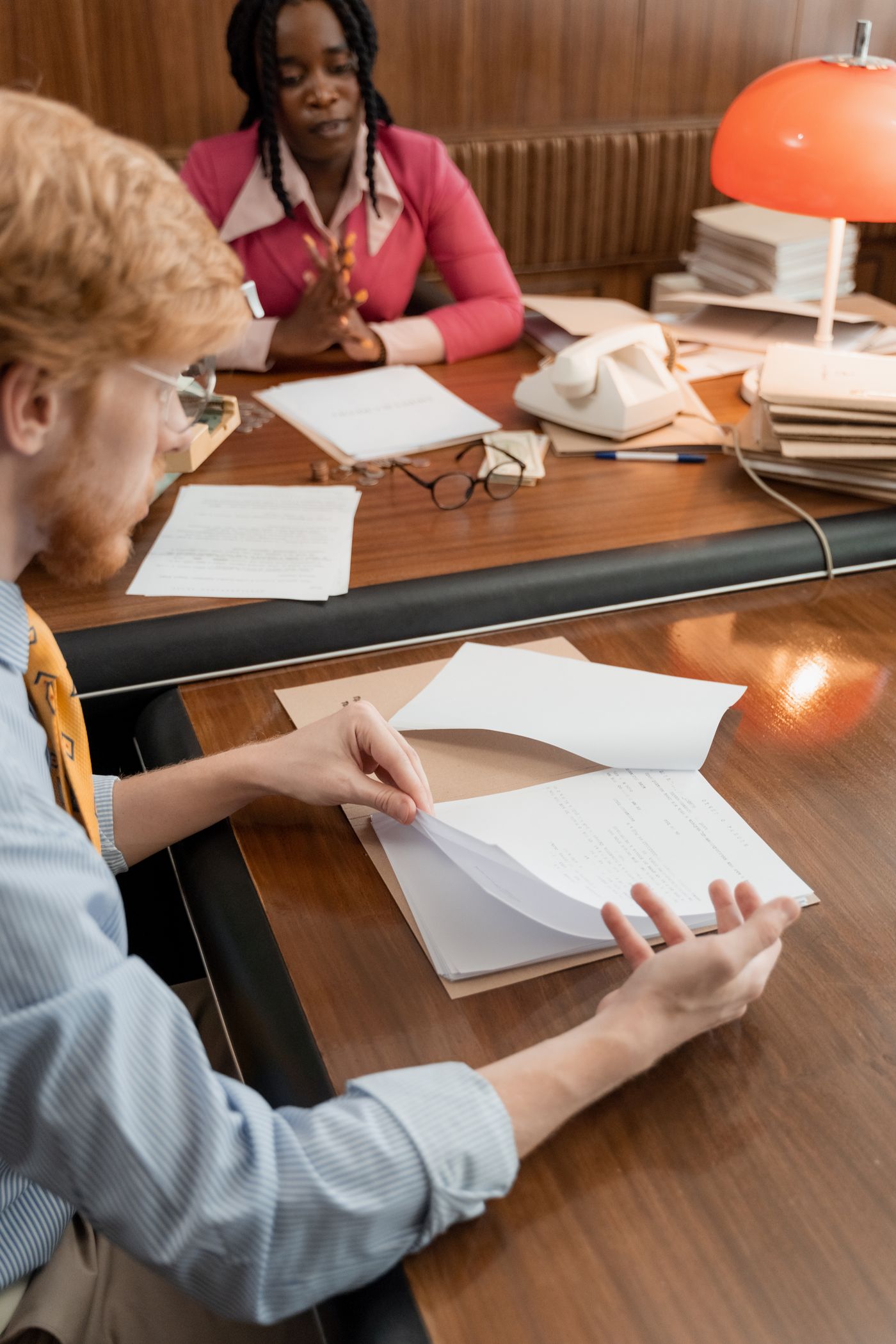 Professionals reviewing printed documents together